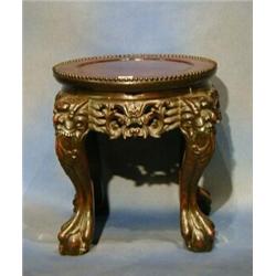 A 19th Century Oriental circular carved hardwood jardiniere stand with pierced decoration raised...