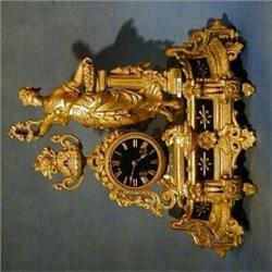 A 19th Century French 8 day striking mantel clock contained in a gilt spelter case supported by a...