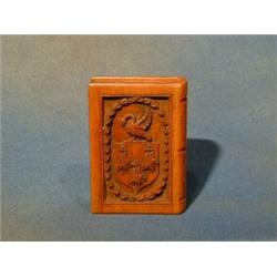 A carved wooden trinket box in the form of a book with armorial decoration 4" £40-50...