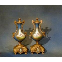 A pair of "Sevres" porcelain and gilt metal mounted urns 10" £50-75...