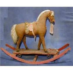 A 19th Century push-a-long rocking horse now raised on rockers (reputedly the property of the Bel...