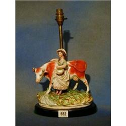 An 18th Century Staffordshire figure of a standing cow with milkmaid, (sympathetically converted...