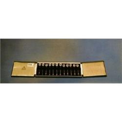 A set of 12 silver and enamel cocktail forks the tops with enamelled playing card decoration, by...
