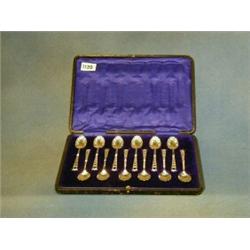 A set of 12 Edwardian silver tea spoons with shell bowls and pierced stems 6 ozs £70-100...