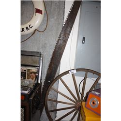 LARGE WOOD SPOKED WAGON WHEEL AND A TWO HANDLED TWO MAN WOOD SAW