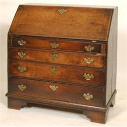 A 19th Century Oak Bureau, the fall front enclosing a stationery compartment, over four graduated...