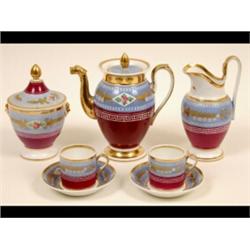 A 19th Century Paris Porcelain Part Coffee Set, painted flowers on a blue ground above a puce low...