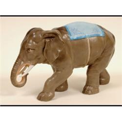 A Late 19th Century Elephant, with a blue rug, anchor mark in underglaze blue, 17 cm  See inside...