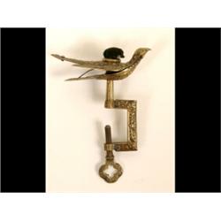 A Victorian Brass Hemming Bird, the needle cushion mounted on a bird, signed PATTENTED FEB 18 (?)...