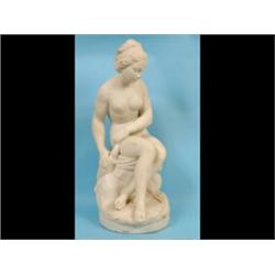 A Carved Marble Figure, of a naked lady, seated on a drape, signed Del Tormone (?) and numbered 1...