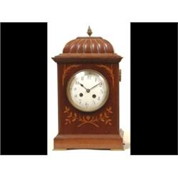 An Edwardian Mantle Clock, with Arabic numerals, striking on a gong, in an inlaid mahogany case,...