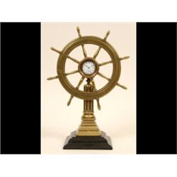A Ship's Wheel Timepiece, with seconds dial, on a fluted column and stepped square base, 36 cm  S...