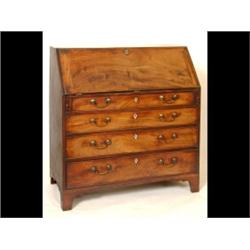 A George III Mahogany Bureau, the fall front revealing a fitted interior, above four graduated lo...