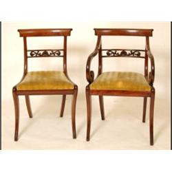 A Set of Six Mahogany Dining Chairs, with carved and pierced splats, drop in seats, and sabre leg...