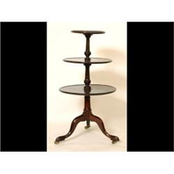 A Mahogany Three Tier Dumb Waiter, the circular tiers on vase turned supports and a tripod base (...