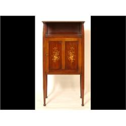 An Edwardian Mahogany Music Cabinet, having a shelf above a paneled door inlaid musical instrumen...