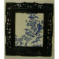 A Chinese Plaque, decorated in under glaze blue a bird amongst foliage, in a carved and pierced f...