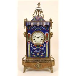 A Mantle Clock, the 10 cm diameter dial with Roman numerals, in a brass and champleve enamel case...