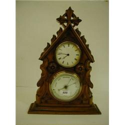 A Late Victorian Desk Timepiece, with barometer and thermometer, in an architectural carved walnu...