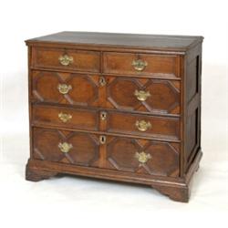 An Early 18th Century Joined Oak Chest, of two short and three long drawers, with geometric mould...