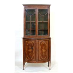 An Edwardian Mahogany Cabinet, the upper section having a pair of bar glazed doors above a bow fr...