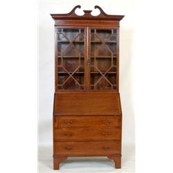 An Edwardian Mahogany Bureau Bookcase, with swan neck pediment above a pair of bar glazed doors,...