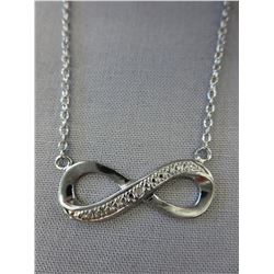 Ladies Infinity design necklace set with a diamond