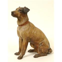 A Terracotta Figure of a Seated Terrier, with glass eyes (very minor damage) 36 cm  See illustrat...
