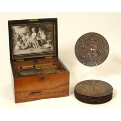 A Table Top Symphonium, playing 19.5 cm diameter discs, in a walnut case, (with later advertising...