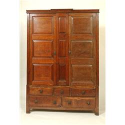 A 19th Century Oak Press Cupboard on Chest, the moulded cornice above a pair of field panel doors...