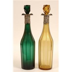 A Pair of Victorian Green and Amber Glass Decanters, with stoppers, with plated grape and vine po...