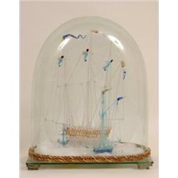 A Nailsea Type Glass Three Masted Sailing Ship, with tender by the side, under a glass dome  See...