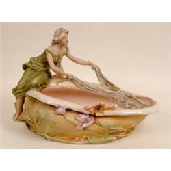 A Royal Dux Table Centrepiece, decorated a woman casting a net (a.f.) 31 cm  See illustration £80...