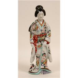 A Kakiemon Style Figure of a Bijin, standing in flowing robes, with enamel decoration, 35 cm  See...