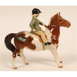 A Beswick Group, girl on pony, skewbald, 1499 See illustration £60 90...
