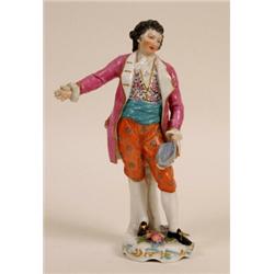 A Porcelain Figure of a Gentleman, wearing a purple coat, on a floral encrusted base, gold anchor...