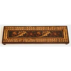 A Tunbridgeware Cribbage Board, with foliate central panel on bun feet  See illustration £40 60...