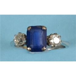 An 18ct White Gold, Diamond and Sapphire Ring, the central square cut sapphire flanked by two dia...