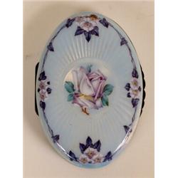 A Silver and Enamel Oval Box, the top decorated a rose and other flowers, 11 cm  See illustration...