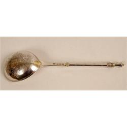 A Russian Silver Spoon, with twist handle, the bowl initialled and with floral engraved decoratio...