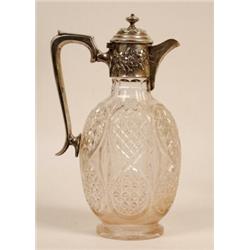 A Cut Glass Claret Jug, of ovoid form, the silver mount embossed foliage, London 1902, 27 cm  See...