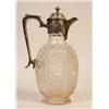 Image 1 : A Cut Glass Claret Jug, of ovoid form, the silver mount embossed foliage, London 1902, 27 cm  See...