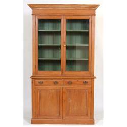 A Late 19th Century Pitch Pine Bookcase, having two glazed doors above two short drawers with cup...