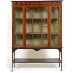 An Edwardian Mahogany Display Cabinet, the frieze inlaid swags above an astragal bar glazed door,...