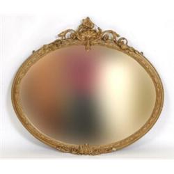 A Victorian Gilt Gesso Oval Wall Mirror, with shell, foliage and flower surmount, 98 x 110 cm  Se...