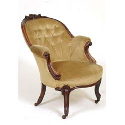 A Victorian Rosewood Button Back Armchair, with carved crest rail, and cabriole front legs  See i...