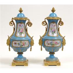 A Pair of Late 19th Century Sevres Style Vases and Covers, decorated flowers in a gilt border on...