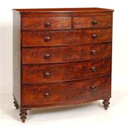 A 19th Century Mahogany Bow Front Chest, with two short and three graduated long drawers, on turn...