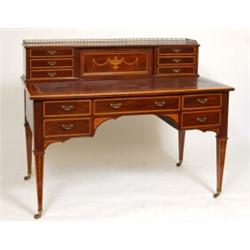A Late Victorian Mahogany Desk, the superstructure with a brass 3/4 gallery above a drop down cup...