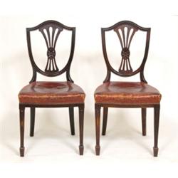 A Set of Eight Late Victorian Mahogany Dining Chairs, the shield shaped backs with pierced vase s...